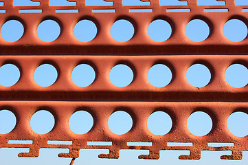 Image showing An old rusty fence with holes