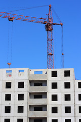 Image showing red crane and blue sky on building site