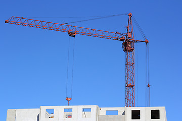 Image showing red crane and blue sky on building site