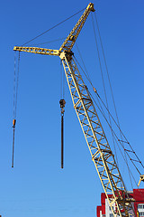 Image showing yellow crane and blue sky on building site