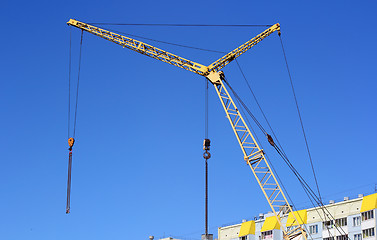 Image showing yellow crane and blue sky on building site