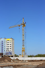 Image showing yellow crane and blue sky on building site