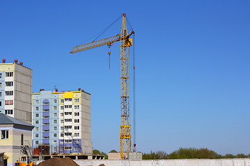 Image showing yellow crane and blue sky on building site