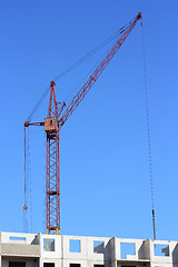 Image showing red crane and blue sky on building site