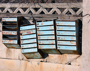 Image showing Old mailboxes are on the fence