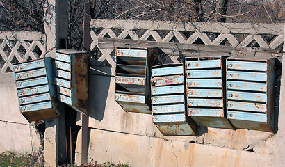 Image showing Old mailboxes are on the fence