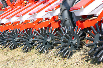 Image showing tractor and seeder planting crops on a field