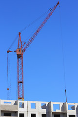 Image showing red crane and blue sky on building site