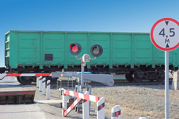 Image showing railroad cars at the crossing with a barrier 