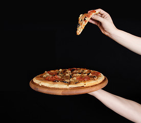 Image showing Tasty pizza and hand