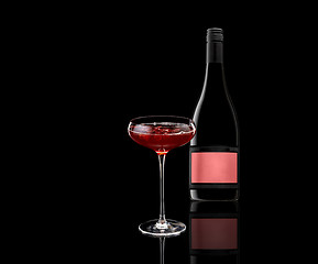 Image showing a glass of red wine and a bottle