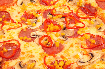 Image showing A Pepperoni pizza with corn background