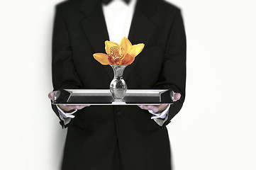 Image showing Waiter holding flower on silver tray