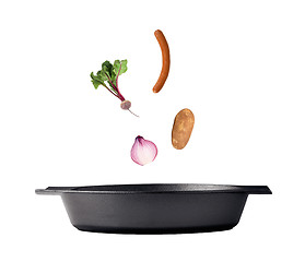 Image showing Flipping veggies with pan studio isolated