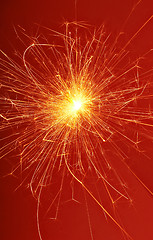 Image showing fireworks sparkler on red background