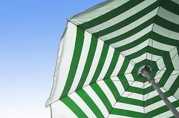 Image showing Colorful beach umbrella against sunny blue sky