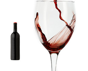 Image showing Red wine pouring down into a wine glass