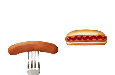 Image showing Grilled hot dog with sausage on fork
