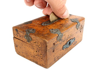 Image showing putting a coin in moneybox