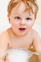 Image showing The little boy bathes in bathing with foam