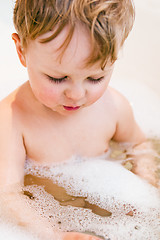 Image showing The little boy bathes in bathing with foam