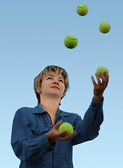 Image showing Woman juggling with tennis balls