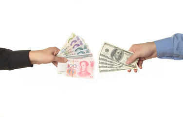 Image showing Hands holding yuan and dollar bills