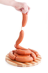 Image showing hand holding sausages