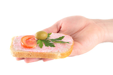 Image showing hand holding toast with fish caviar cream