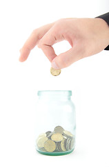 Image showing coin dropping in glass jar