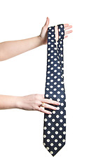 Image showing man holding polka dot tie