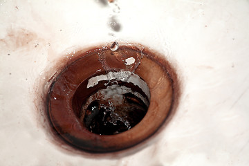 Image showing Waterdrops falling into vintage sink