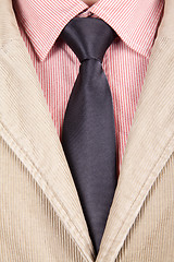 Image showing Close-up of red striped shirt with black tie