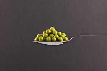 Image showing fresh frozen peas on spoon