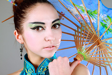 Image showing Young beautiful china girl with umbrella