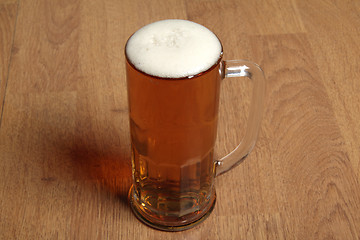 Image showing Single beer glass on wooden table