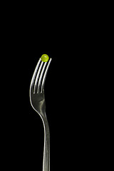 Image showing Fresh green peas on a silver fork