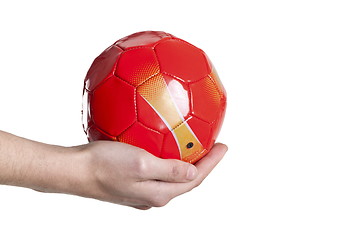 Image showing small soccer red ball in hand. Isolated