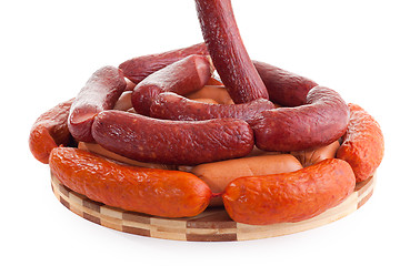 Image showing various sausages on wooden plate