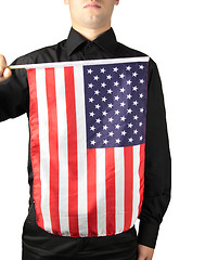 Image showing Businessman in black suit holding a flag