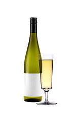 Image showing Full white wine glass goblet and bottle isolated