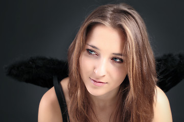 Image showing young beautiful girl with black wing