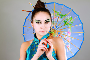 Image showing Young beautiful china girl with umbrella