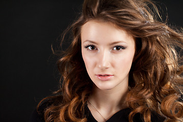 Image showing portrait of beautiful girl with brown hair on black