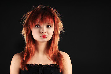Image showing Attractive girl with red hair on a black background