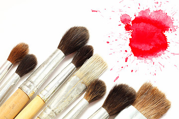 Image showing Set of brushes and red blot