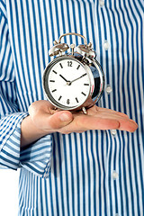 Image showing Boys palm holding alarm clock