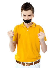 Image showing Angry boy with masking tape on mouth.