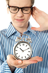 Image showing Boy irritated with noise of alarm clock