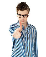 Image showing Serious boy gesturing thumbs up